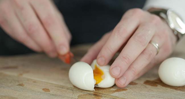sliced soft boiled egg on a cutting board