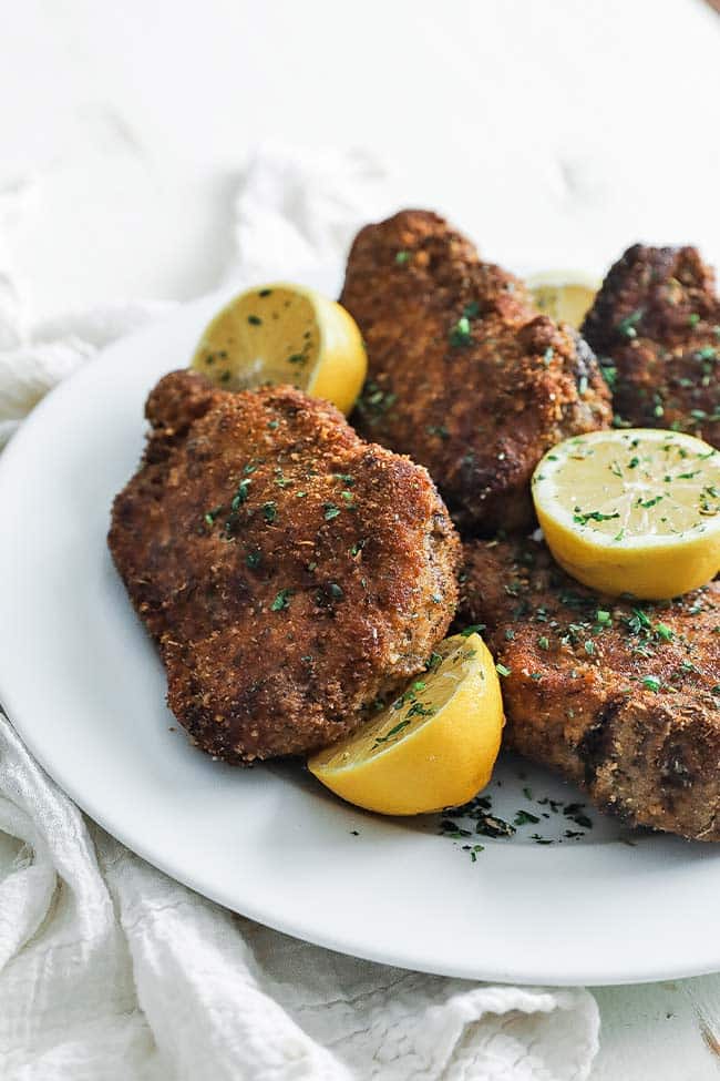 a plate full of fried pork chops with breading