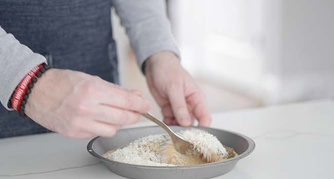 mixing bread crumbs and spices together in a pan