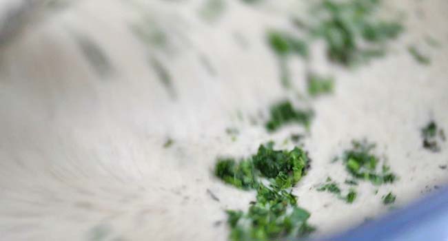 finishing a cream of mushroom soup with herbs