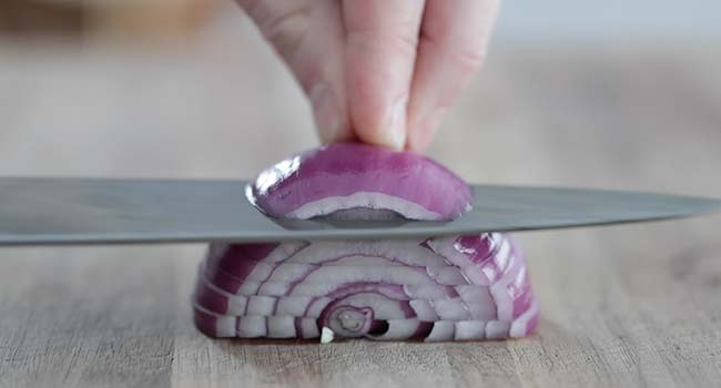 slicing a red onion