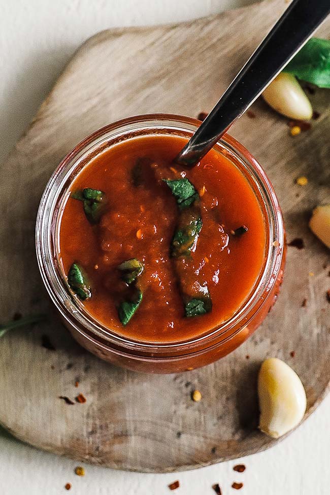 basil and pizza sauce in a jar