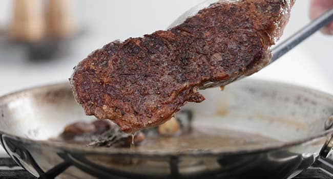 a pan seared steak in a pan