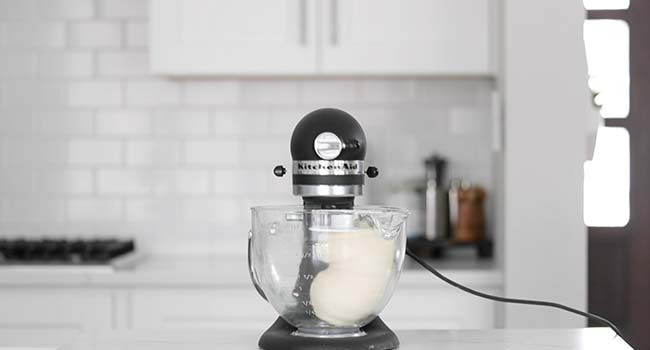 mixing pizza dough in a standing mixer