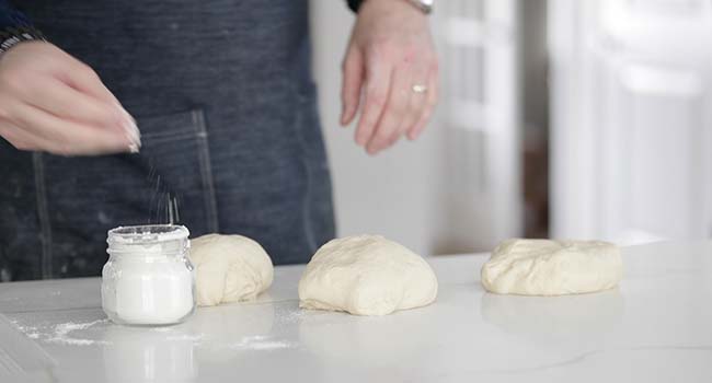 separating pizza dough into 3 balls