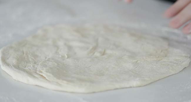 forming and flattening a pizza dough