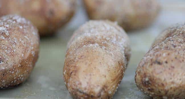 salted baked potato on a sheet tray