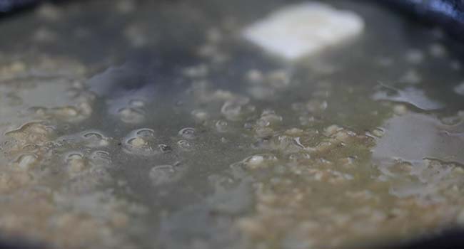 making a butter sauce with shallots in a pan