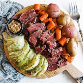 platter of sliced corned beef and vegetables