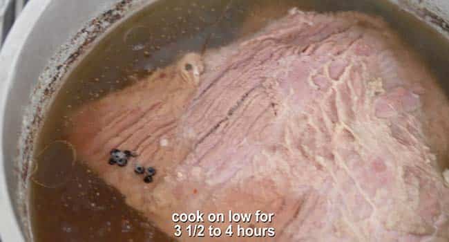 cooked corned beef in a pot of water