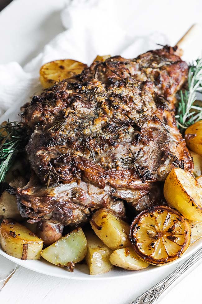 bone in roasted leg of lamb with herbs and potatoes