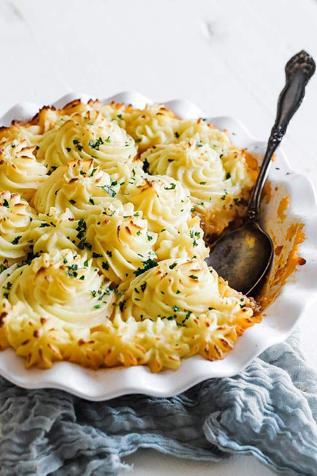 scooping shepherd's pie out of a dish