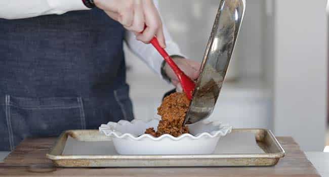 adding shepherd's pie stuffing to a pie casserole dish