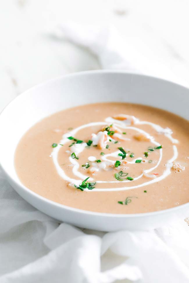 a bowl of creamy shrimp bisque with sour cream