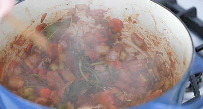 mixing tomato paste with with mirepoix