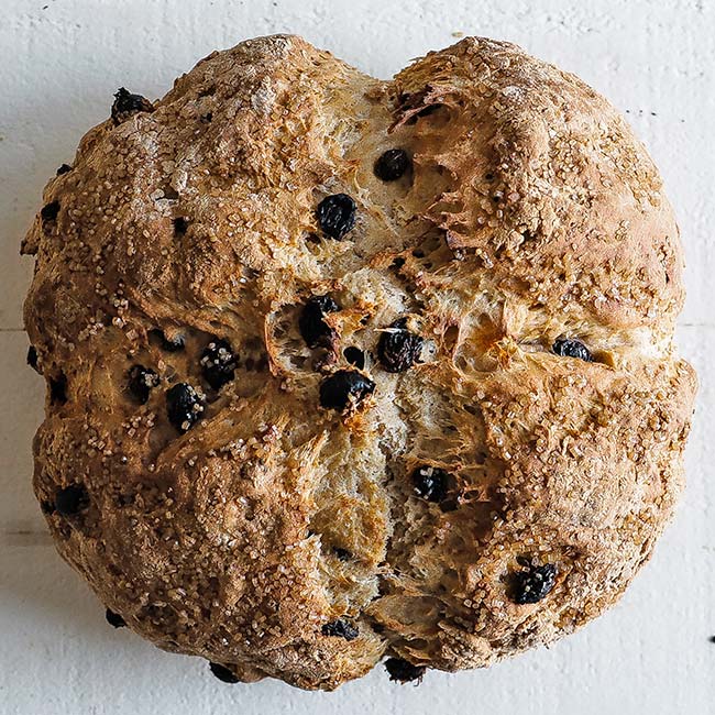 loaf of baked irish soda bread with raisins