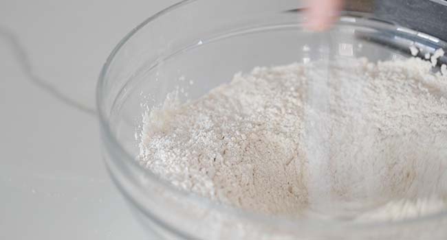 whisking together flours in a bowl