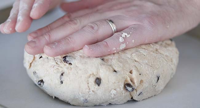 pressing down soda bread dough