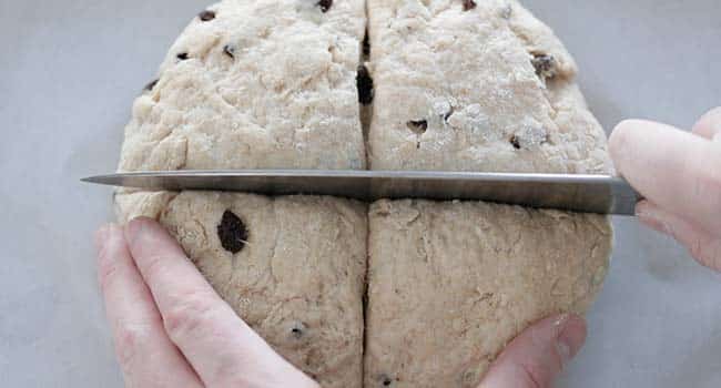 slicing soda bread dough before baking