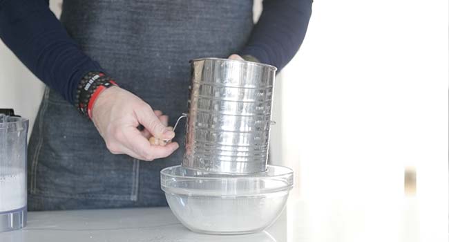 sifting flour into a bowl