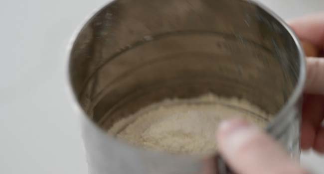 sifting flour into a bowl