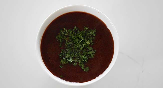 birria consome in a bowl for the birria tacos