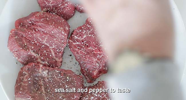 seasoning filet mignons with salt and pepper