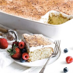 plate with tres leches cake and fresh berries