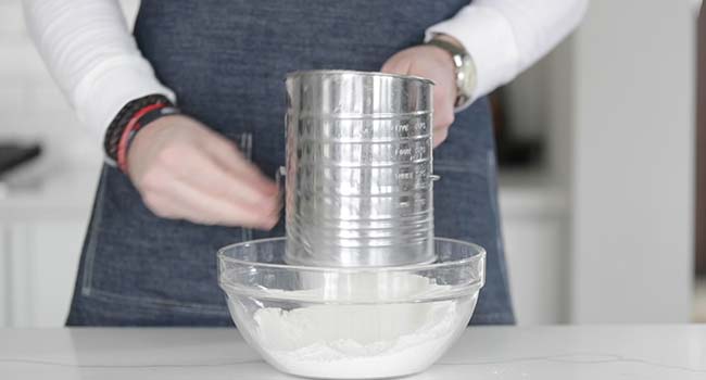 sifting flour into a bowl