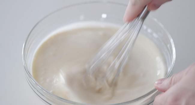 whisking together different kinds of milk in a bowl