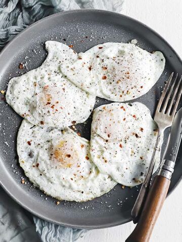 plate of fried eggs with salt and pepper