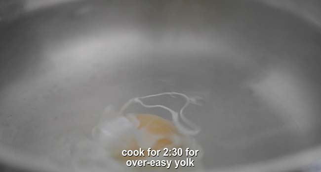 an egg poaching in hot water in a pot