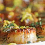 pan seared scallop with herb butter and lemon zest