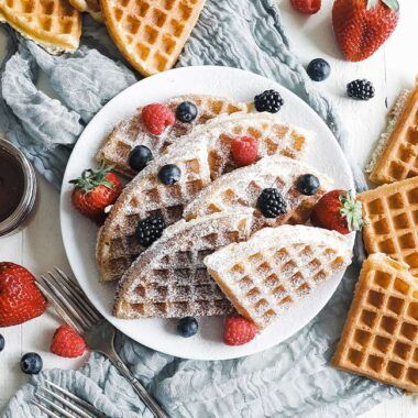 plate full of waffles with berries