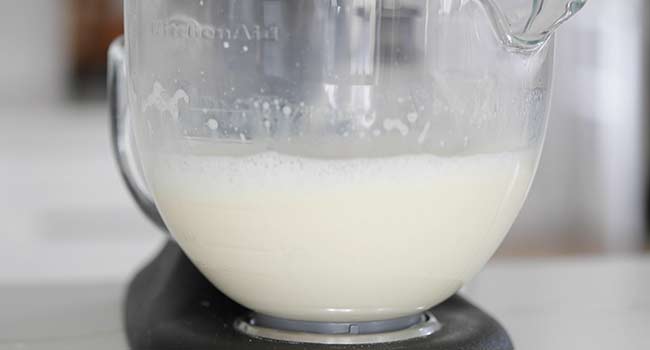 mixing eggs with milk in a stand mixer