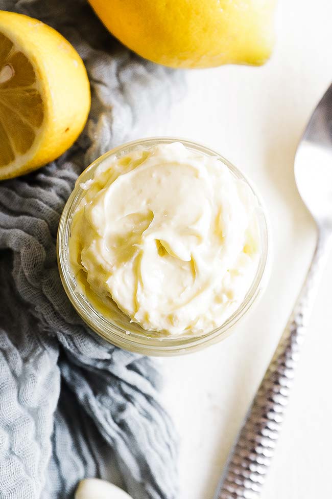 homemade garlic aioli in a jar with a spoon