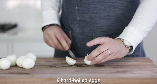 slicing hard boiled eggs in half