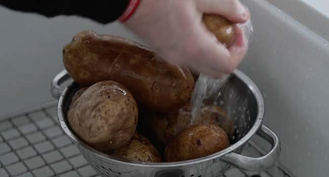 washing potatoes in the sink