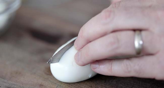 slicing a hard boiled egg in half
