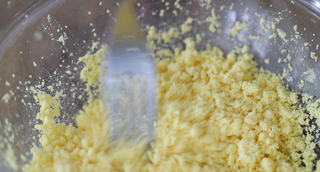 mashing egg yolks in a bowl