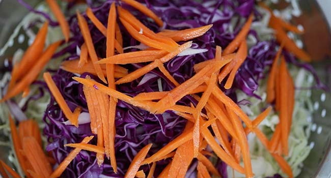 shredded carrots and red cabbage in a bowl