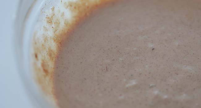 mixing together a homemade comeback sauce in a bowl