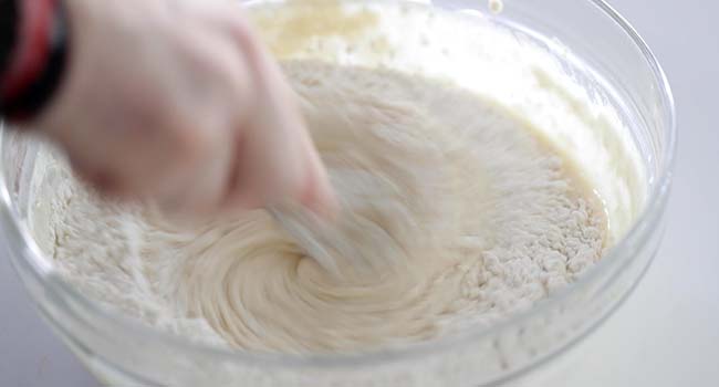 whisking a funnel cake batter