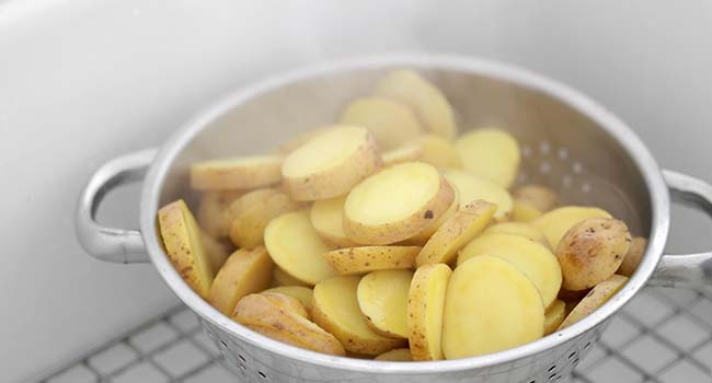 draining cooked potatoes in a colander 