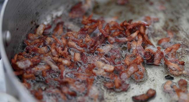 cooking thick cut bacon in a pan