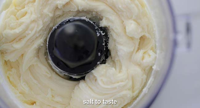 finishing a homemade mayonnaise with lemon juice and salt