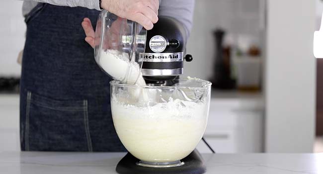 pouring flour into a stand mixer bowl