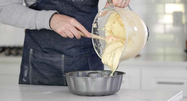 transferring pound cake batter to a mold