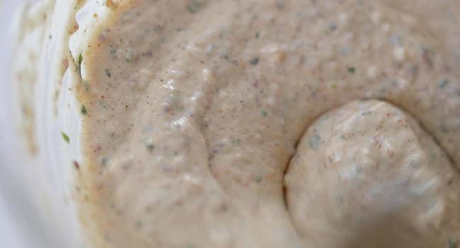 stirring a homemade cajun remoulade sauce in a bowl