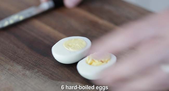 slicing a hard boiled egg in half